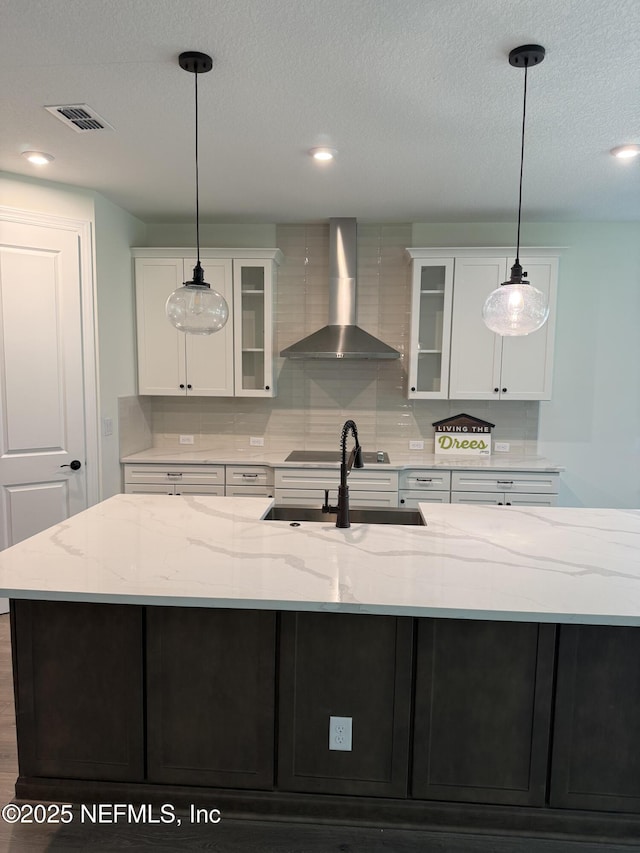 1040 Creighton Rd, Fleming Island, FL 32003 - kitchen featuring wall chimney range hood, a sink, white cabinetry, glass insert cabinets, and backsplash
