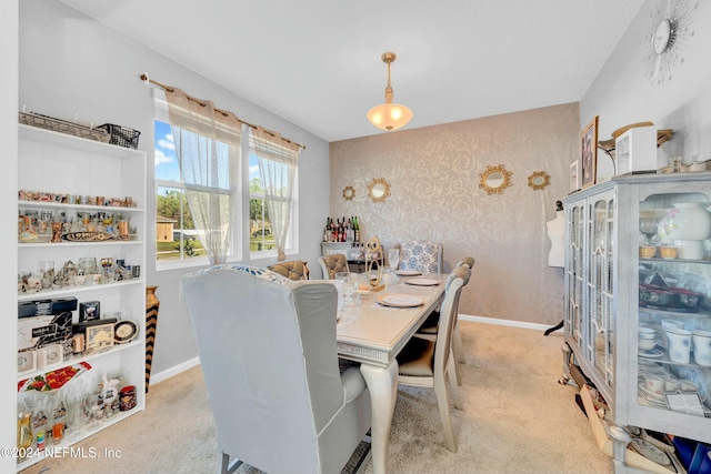 dining room featuring light colored carpet