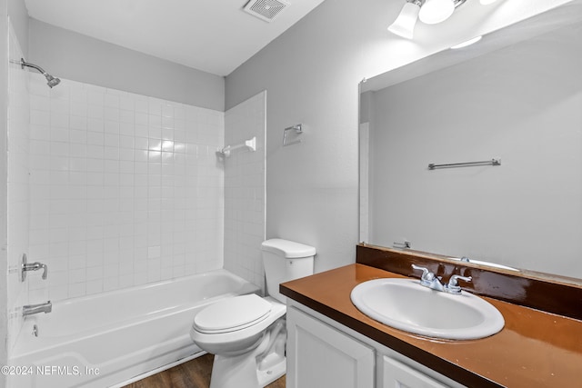 full bathroom with wood-type flooring, vanity, toilet, and tiled shower / bath combo