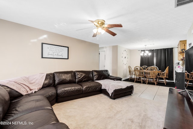 carpeted living room featuring ceiling fan with notable chandelier and a textured ceiling