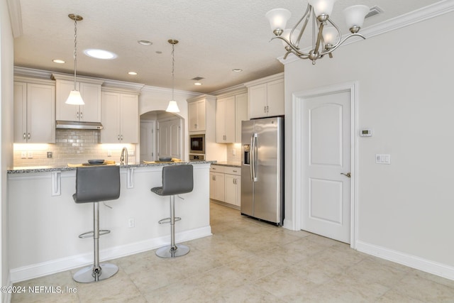 kitchen featuring a kitchen breakfast bar, light stone counters, stainless steel appliances, and decorative light fixtures