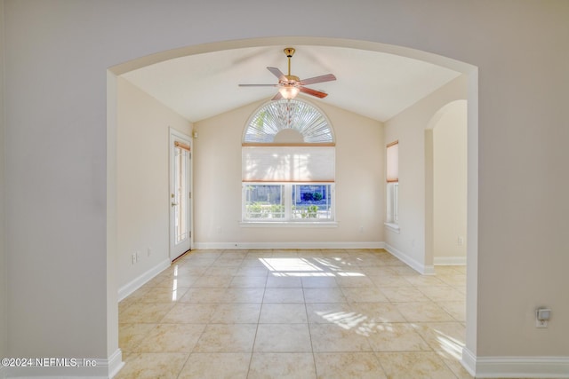 tiled spare room featuring ceiling fan and lofted ceiling