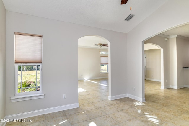 empty room featuring a textured ceiling and ornamental molding