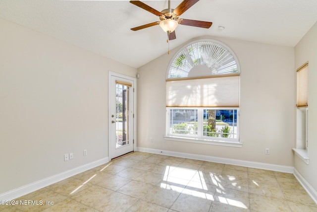 tiled empty room featuring ceiling fan and lofted ceiling