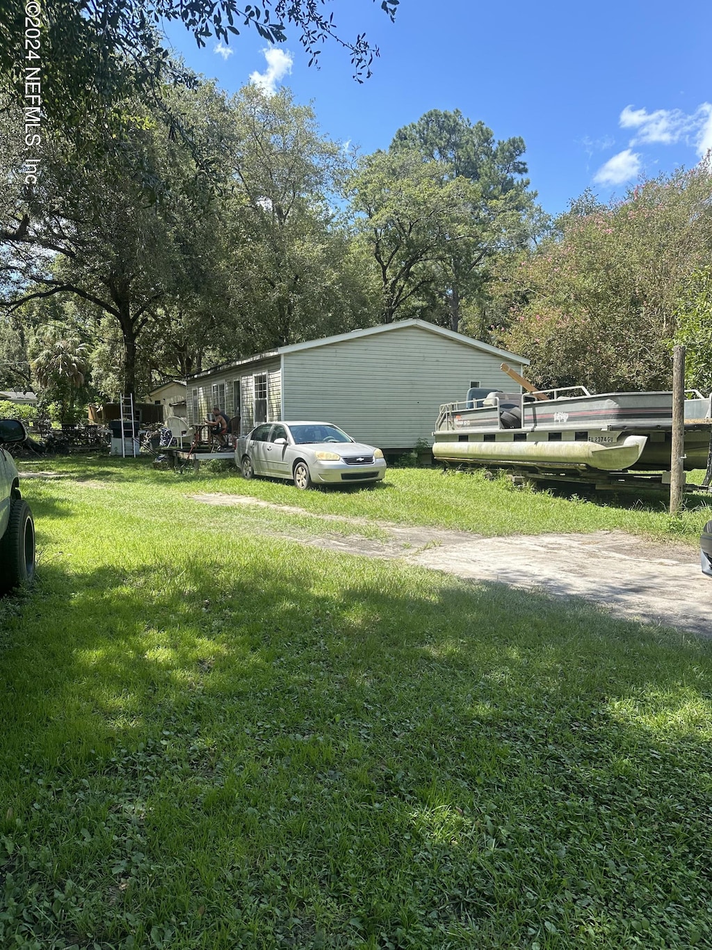 view of side of home with a yard