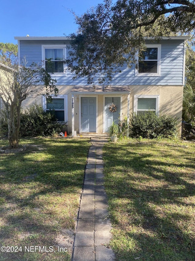 front facade with a front lawn