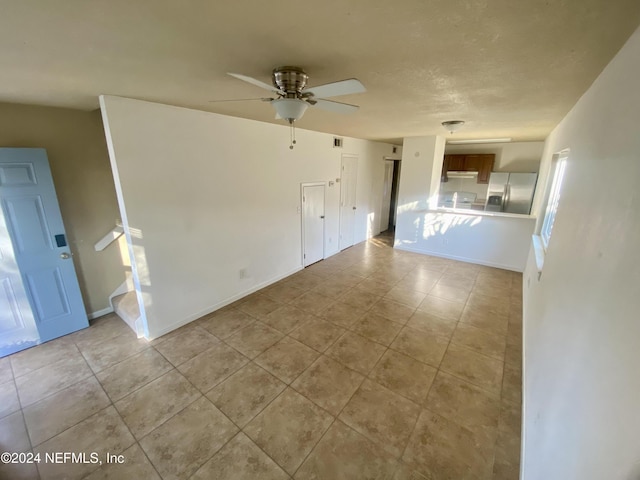 unfurnished living room featuring ceiling fan