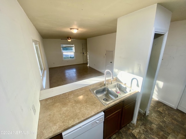 kitchen with dark brown cabinets, white dishwasher, ceiling fan, and sink