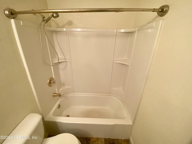 bathroom featuring washtub / shower combination and toilet