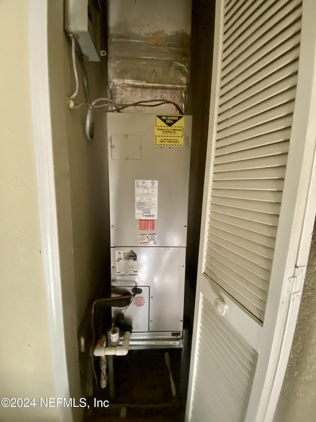 utility room featuring heating unit