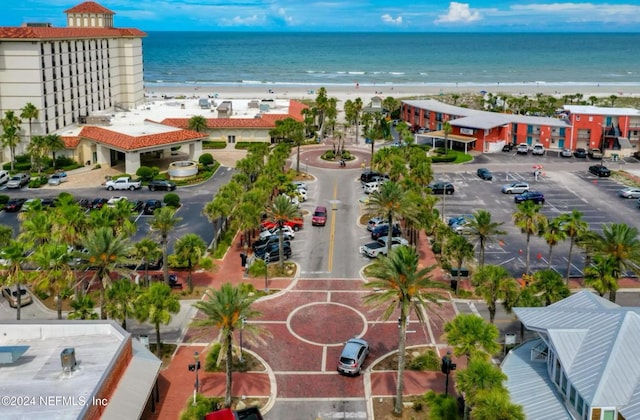 drone / aerial view featuring a water view and a view of the beach