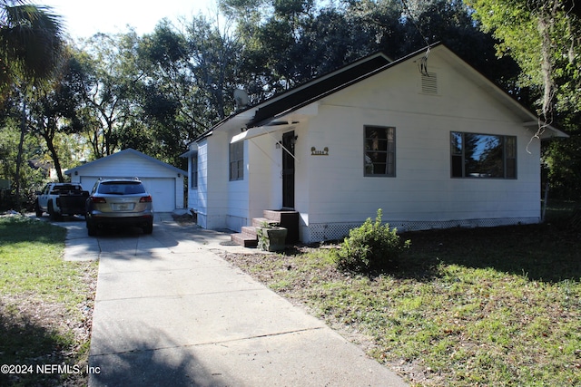 view of front of property with a garage and an outdoor structure