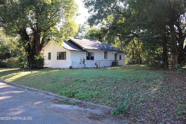 view of property exterior featuring a lawn