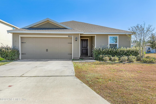 ranch-style house with a front lawn and a garage