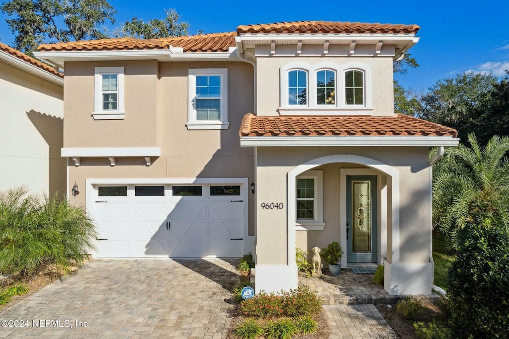 mediterranean / spanish house featuring a garage