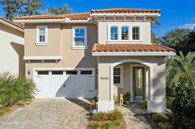 mediterranean / spanish house featuring a garage