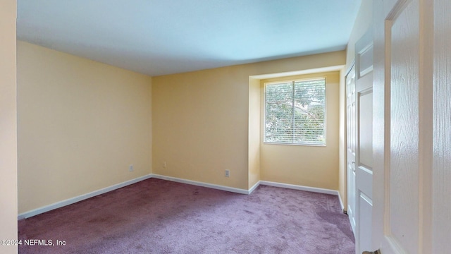 unfurnished room with light colored carpet