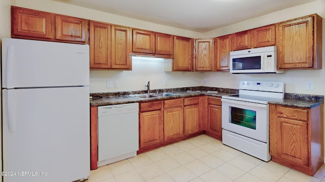 8880 Old Kings Rd S Unit 106, Jacksonville, FL 32257 - kitchen featuring white appliances, brown cabinets, and dark countertops