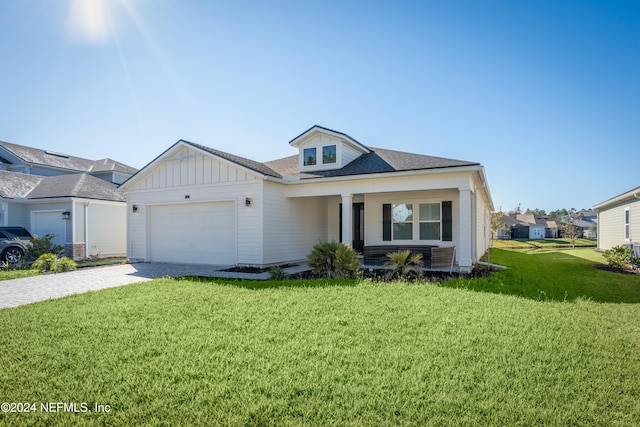 view of front of property with a garage and a front yard