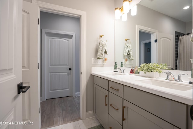 bathroom with hardwood / wood-style floors and vanity