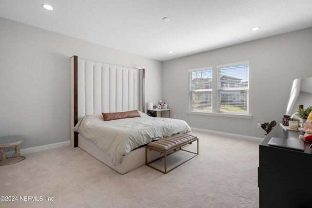 bedroom featuring light carpet