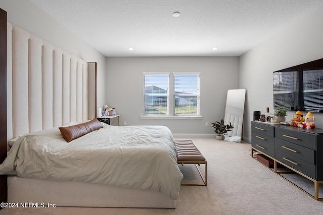 carpeted bedroom with a textured ceiling