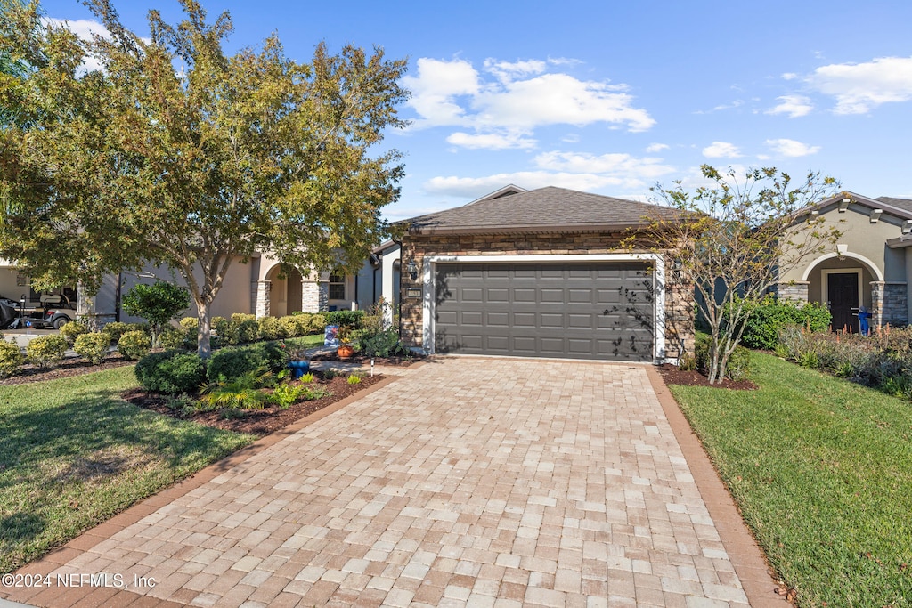 view of front facade with a front yard and a garage