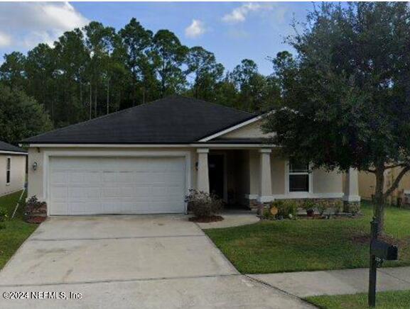 view of front of home with a garage and a front yard