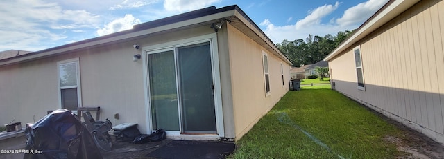 view of side of property with a lawn