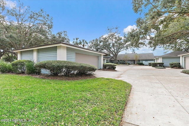 view of side of home with a garage and a yard