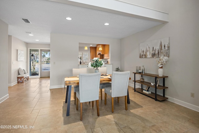 dining space with sink and a textured ceiling