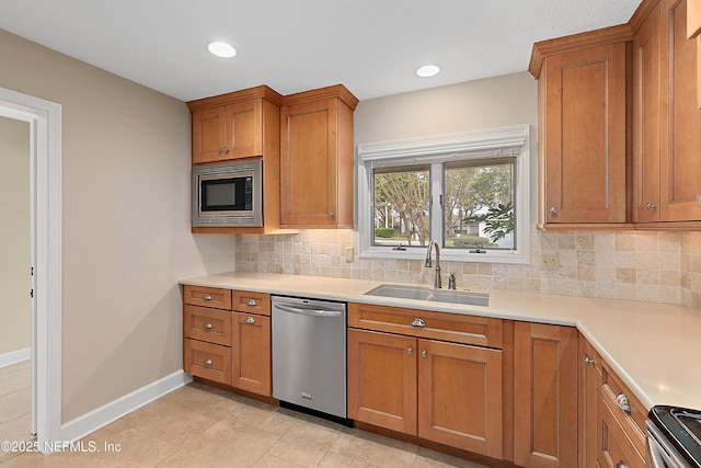 kitchen with stainless steel appliances, sink, and backsplash