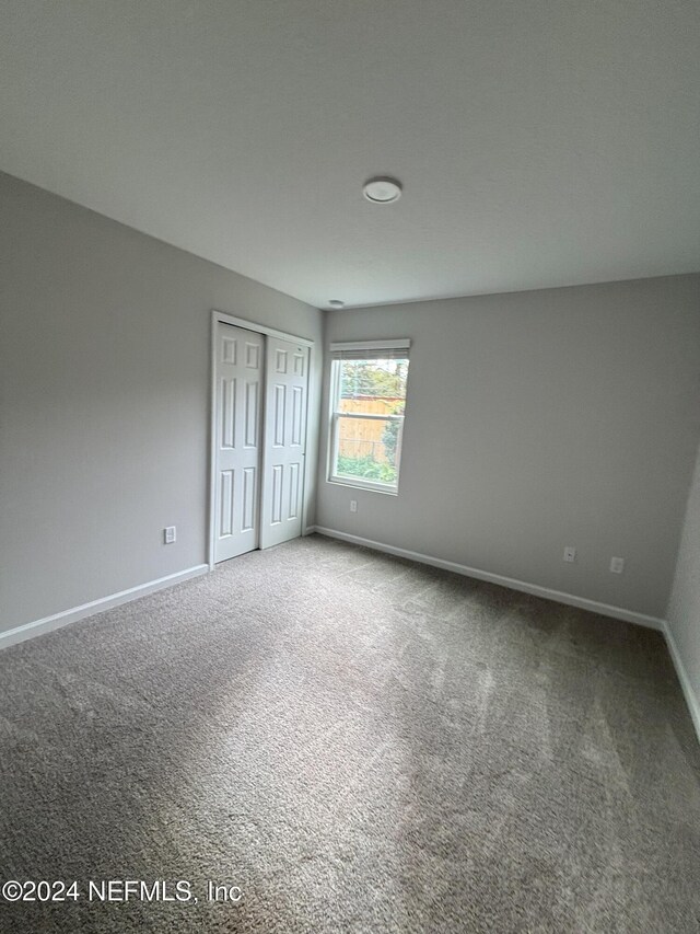 unfurnished bedroom featuring carpet flooring