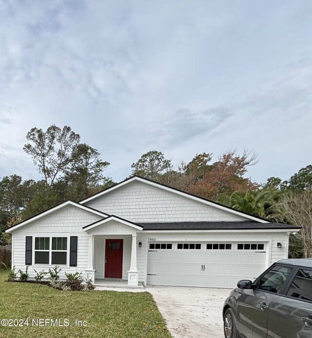 view of front facade with a front yard and a garage