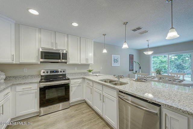 kitchen with sink, white cabinets, and appliances with stainless steel finishes