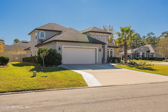 view of front of house with a garage and a front lawn