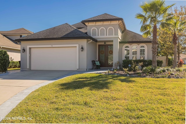 view of front of property with a garage, french doors, and a front lawn