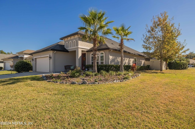 view of front of property featuring a front yard and a garage