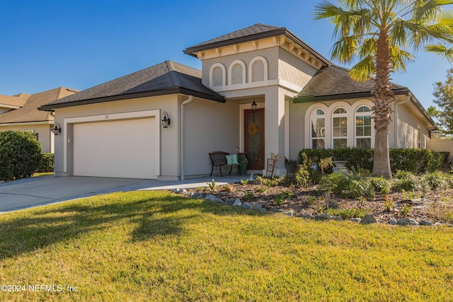 view of front of house featuring a garage and a front lawn