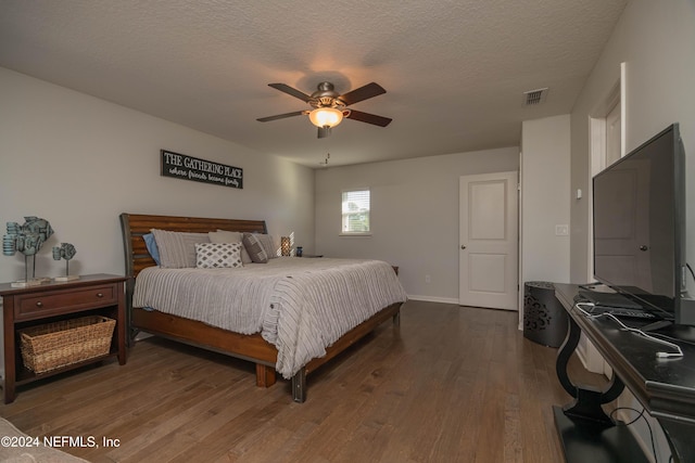 bedroom featuring wood-type flooring, a textured ceiling, and ceiling fan