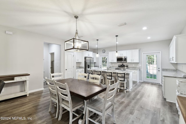 dining room with a chandelier and hardwood / wood-style floors