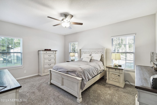 bedroom featuring multiple windows and ceiling fan