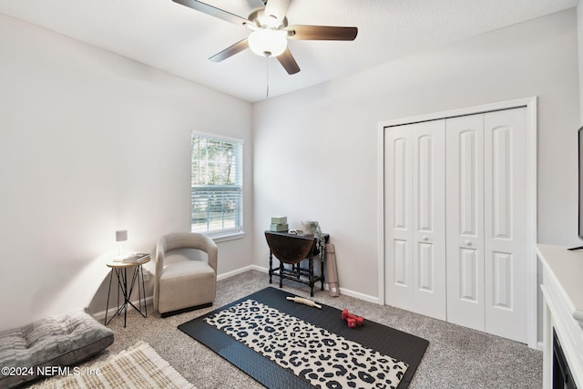 sitting room with carpet and ceiling fan