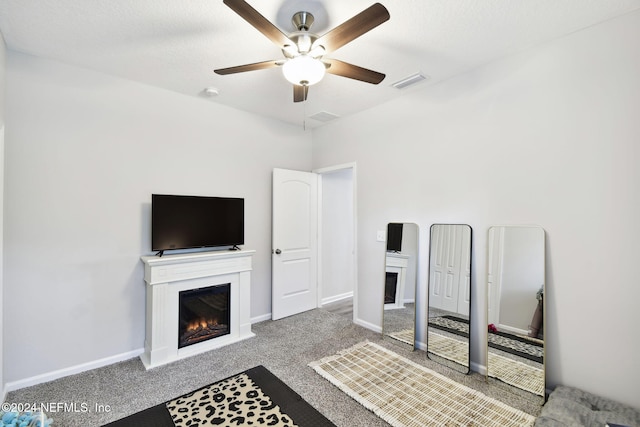 carpeted living room with ceiling fan