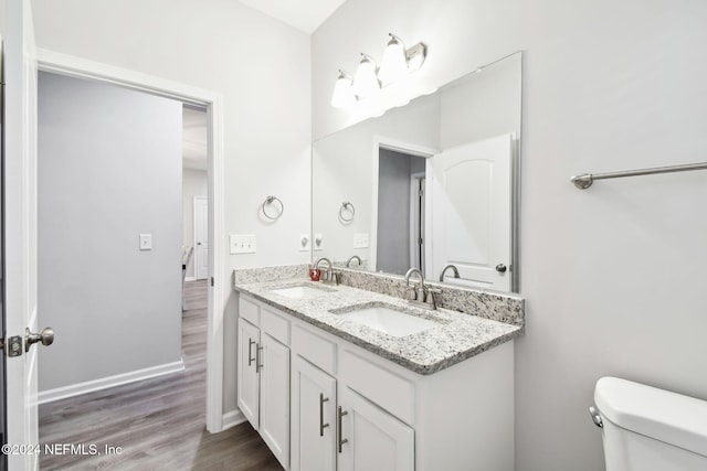 bathroom featuring hardwood / wood-style floors, vanity, and toilet