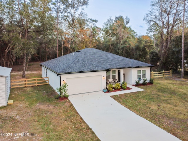 single story home with a garage and a front yard