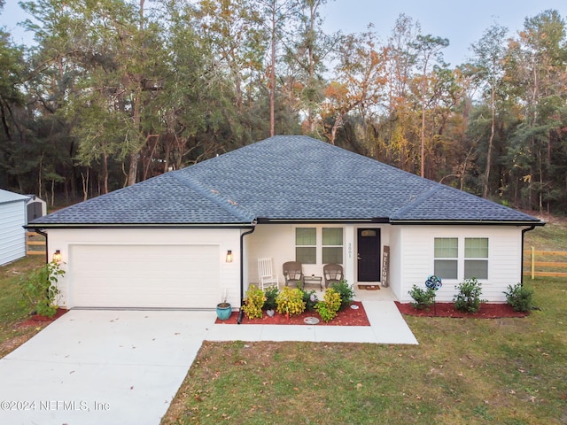 view of front of home with a garage and a front lawn