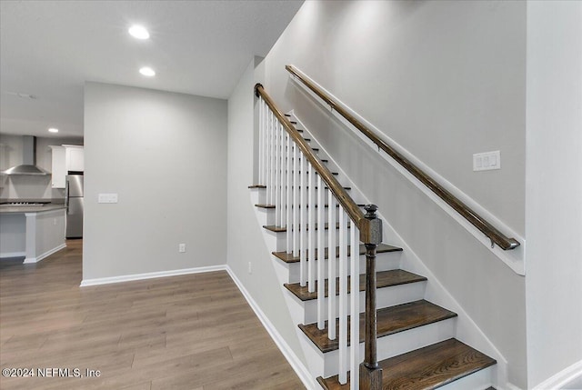 staircase with wood-type flooring