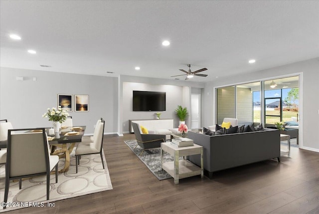 living room with ceiling fan and dark hardwood / wood-style flooring