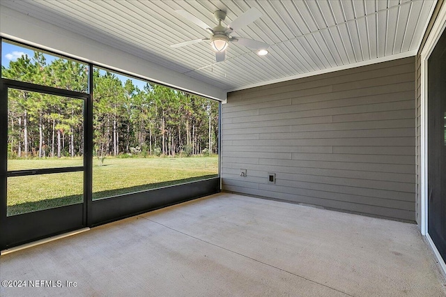 unfurnished sunroom featuring ceiling fan